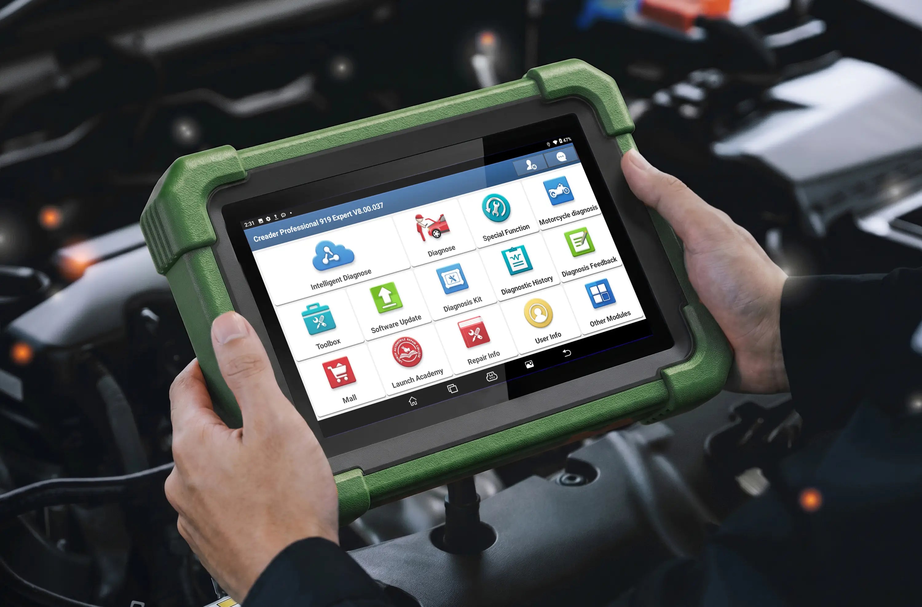 A person holds a LAUNCH CRP 919 Advanced diagnostic scanner over an open car engine bay. The device is enclosed in a rugged orange protective bumper and features a touchscreen displaying various automotive diagnostic menu icons.
