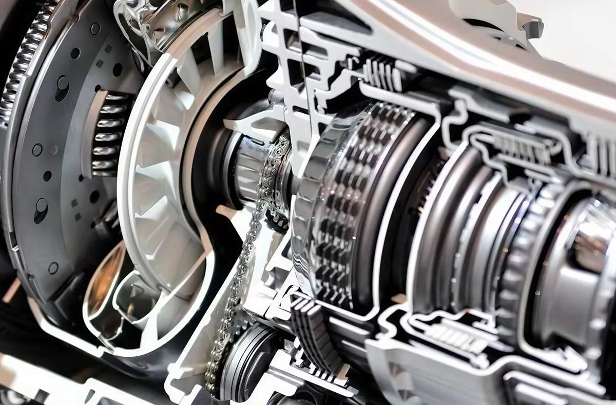 Shows a technician's hand checking fluid levels with a dipstick over an open car engine bay, alongside a professional automotive diagnostic tablet showing live graphs.